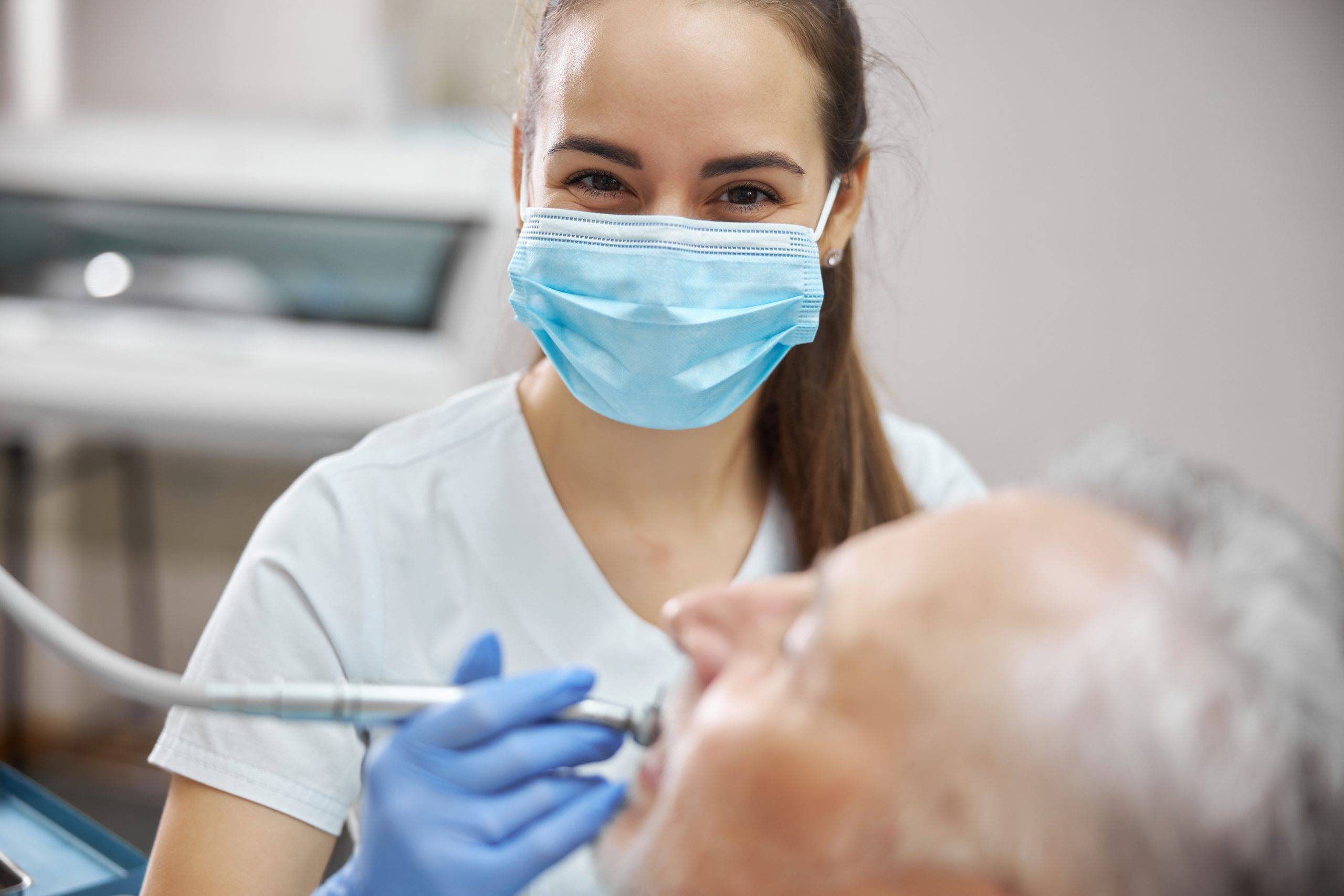 beautiful-female-dentist-using-a-scaled.jpeg